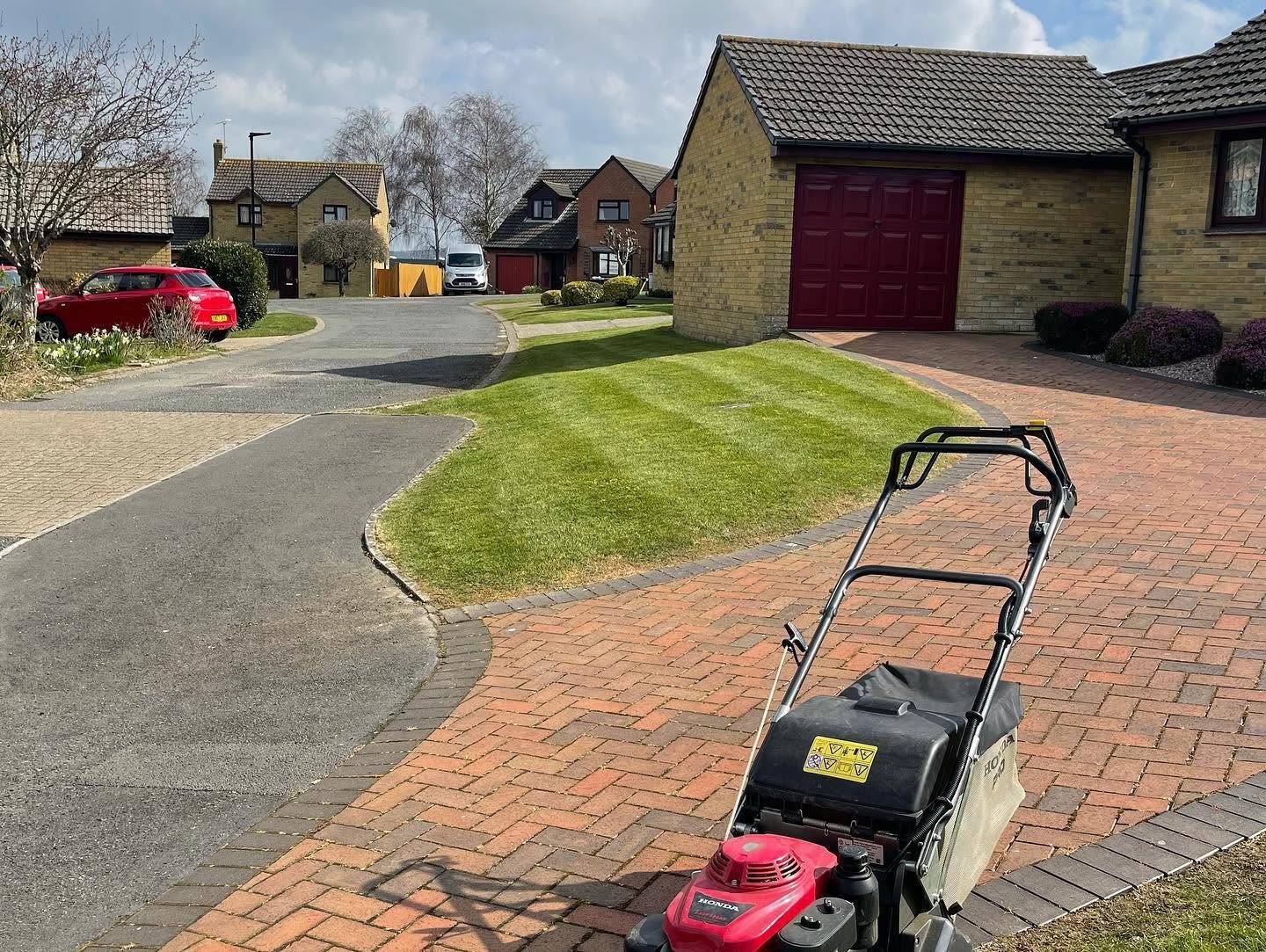 Garden lawn beside a brick-paved drive