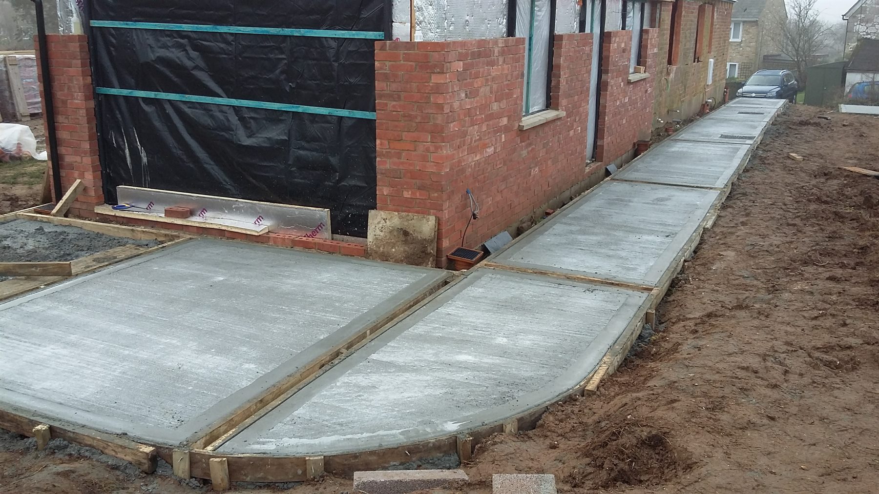 New concrete paths and driveway being formed beside a house