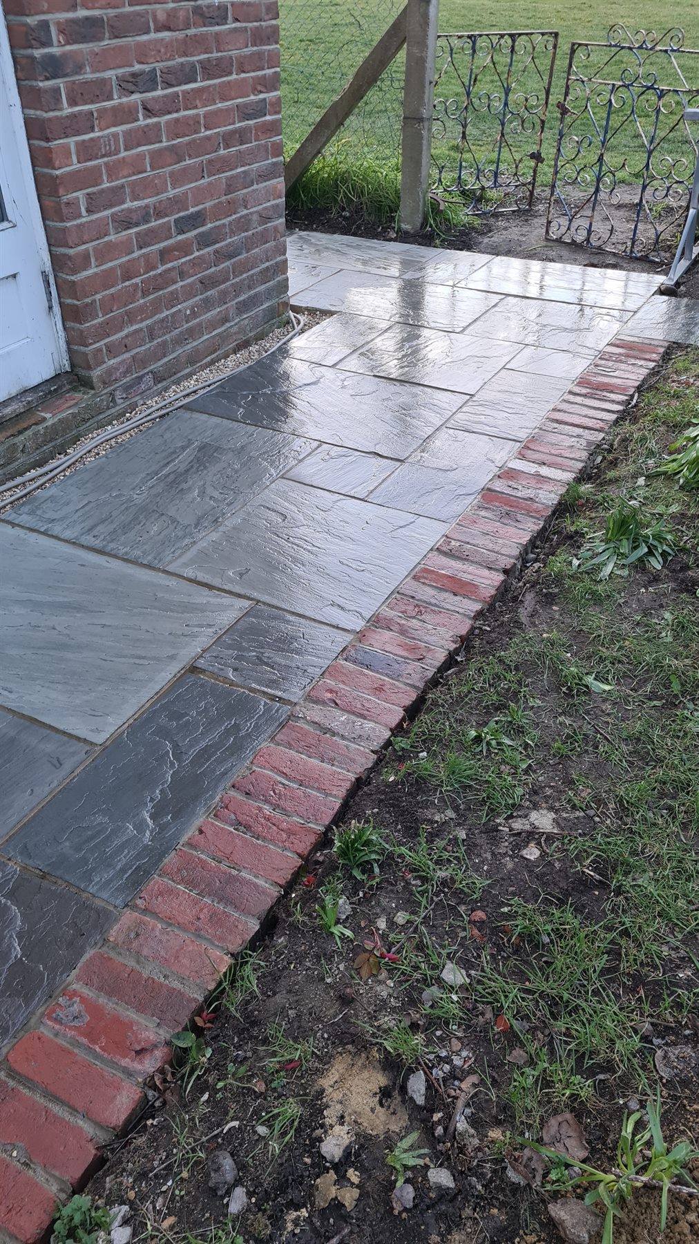 Stone paving and brick edging in a residential garden