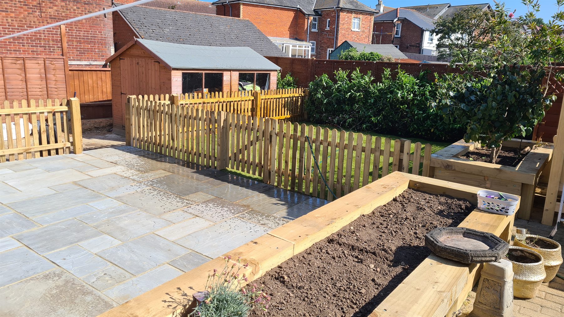 Completed stone patio with a brick border
