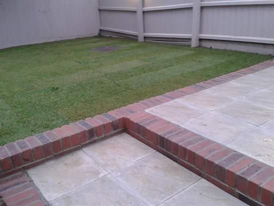 New slate path with brick edging outside a home