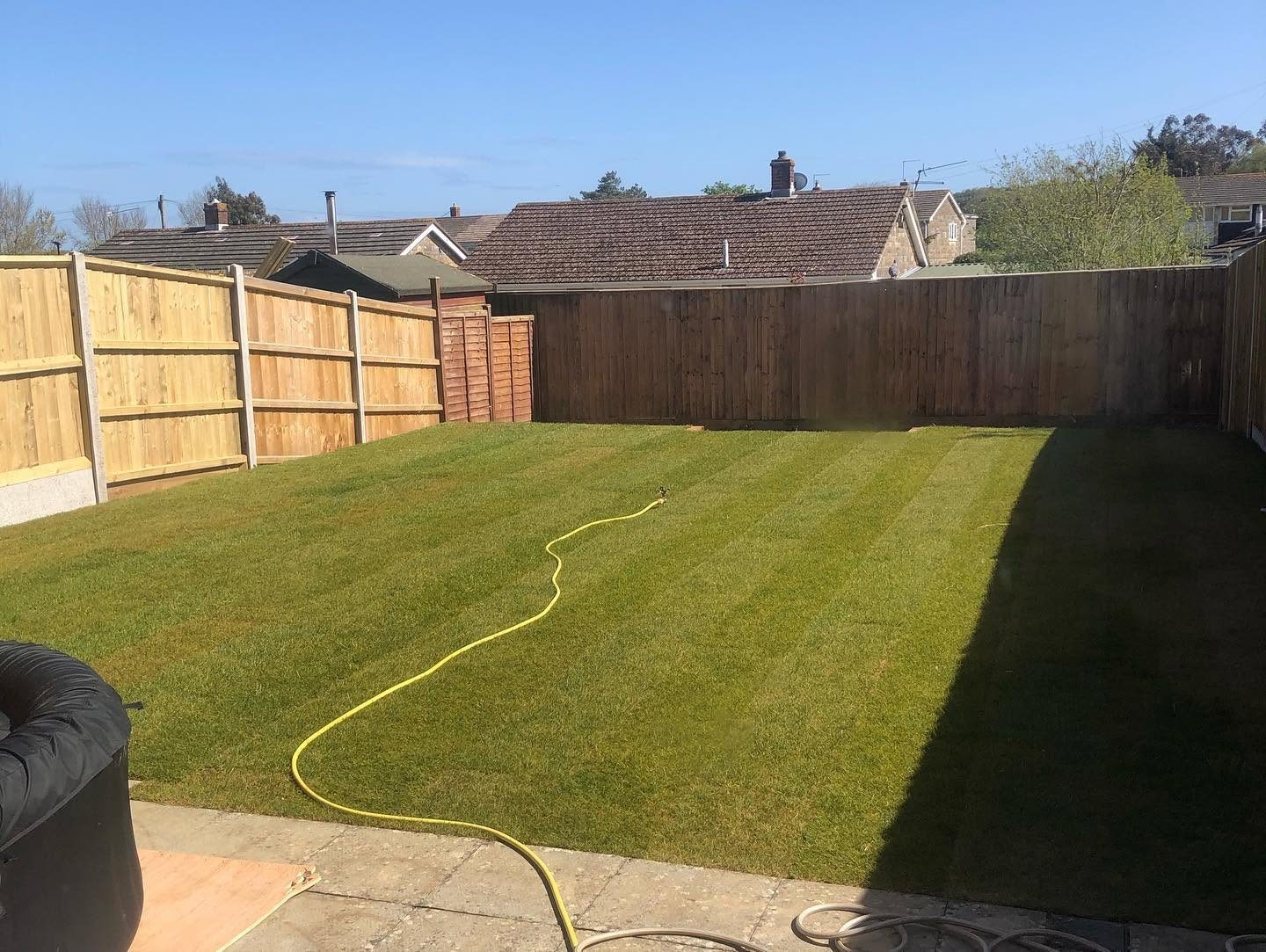 Finished lawn enclosed by a new timber fence