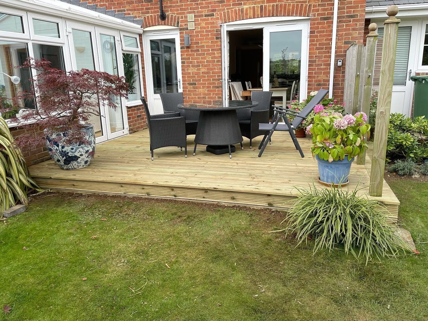 Paved garden patio with a new raised planting bed