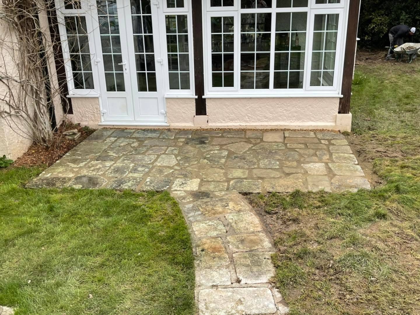 Stone-paved path beside the exterior wall of a home