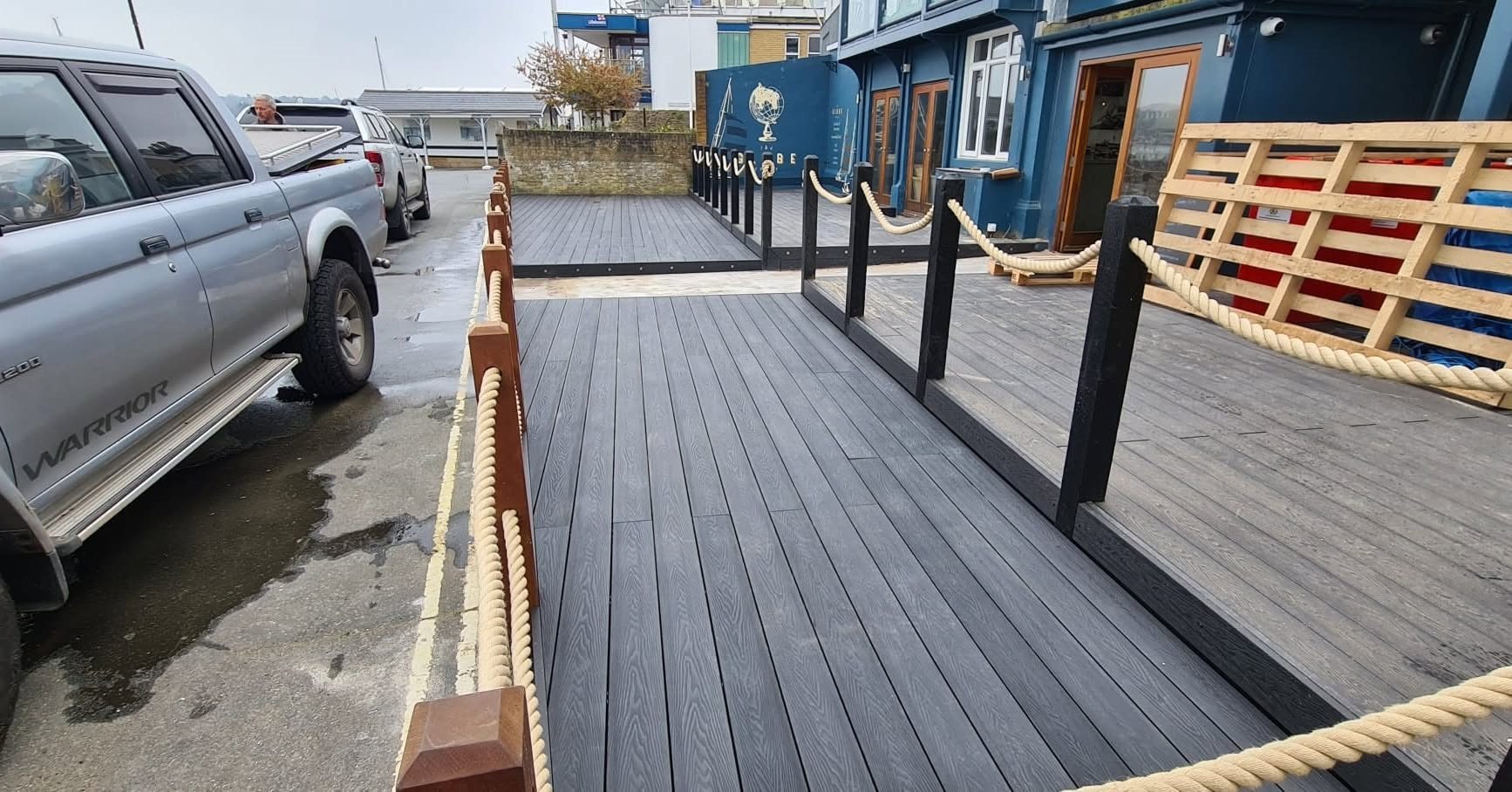 Raised composite decking beside a garden