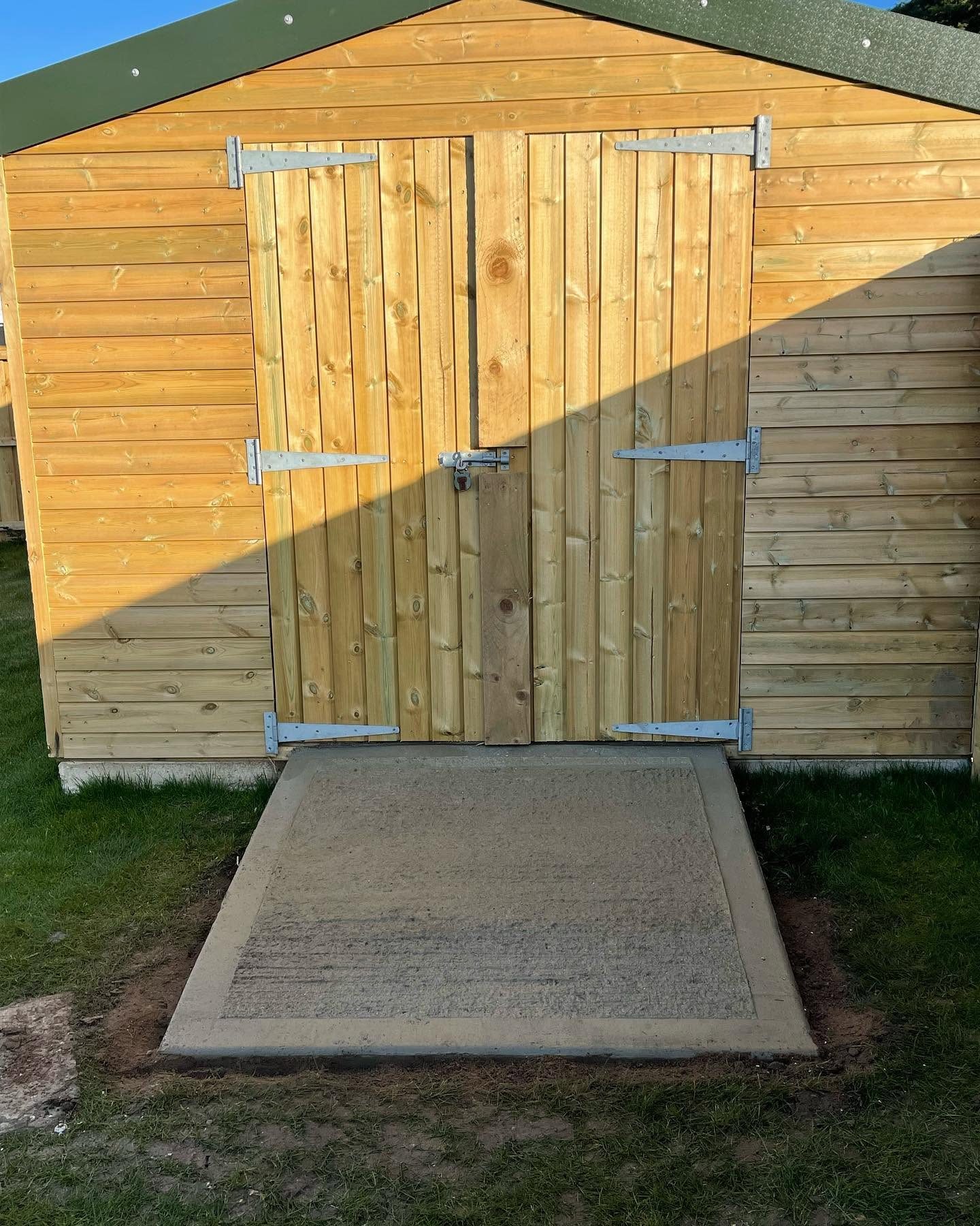 Timber garden shed with a newly prepared concrete base