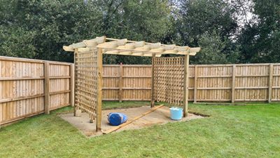 Pergola, path and fencing in a landscaped garden