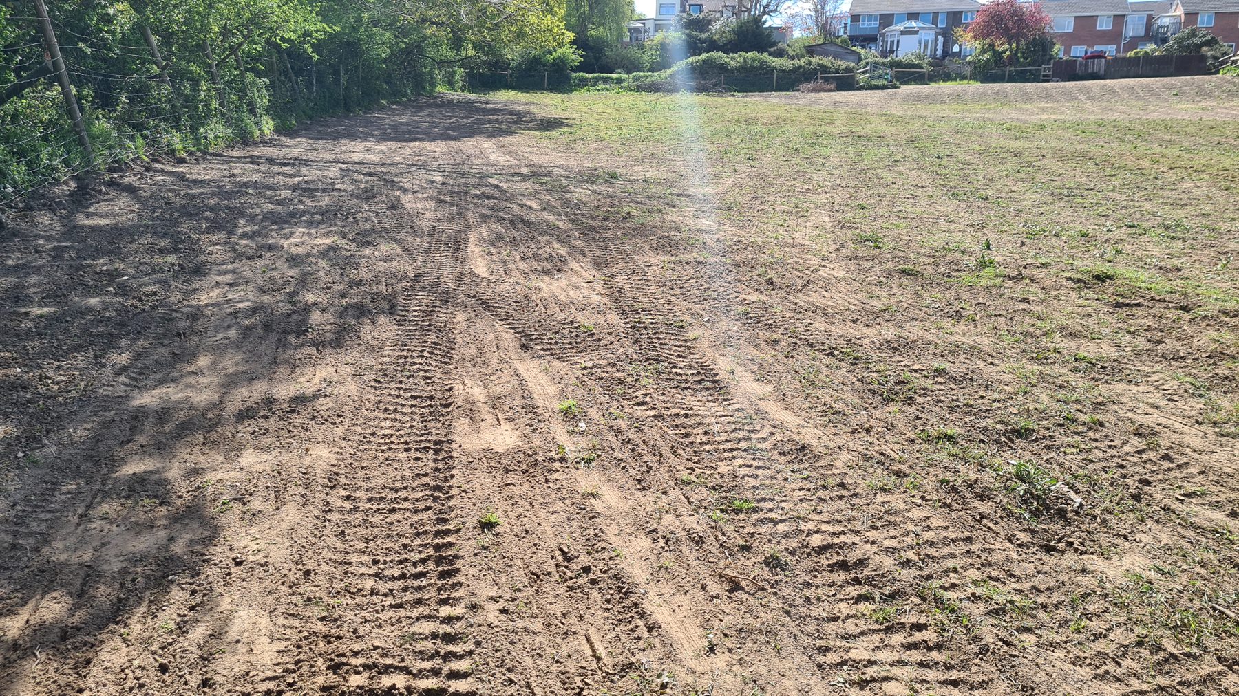 Paddock soil prepared in parallel passes ready for grass seed