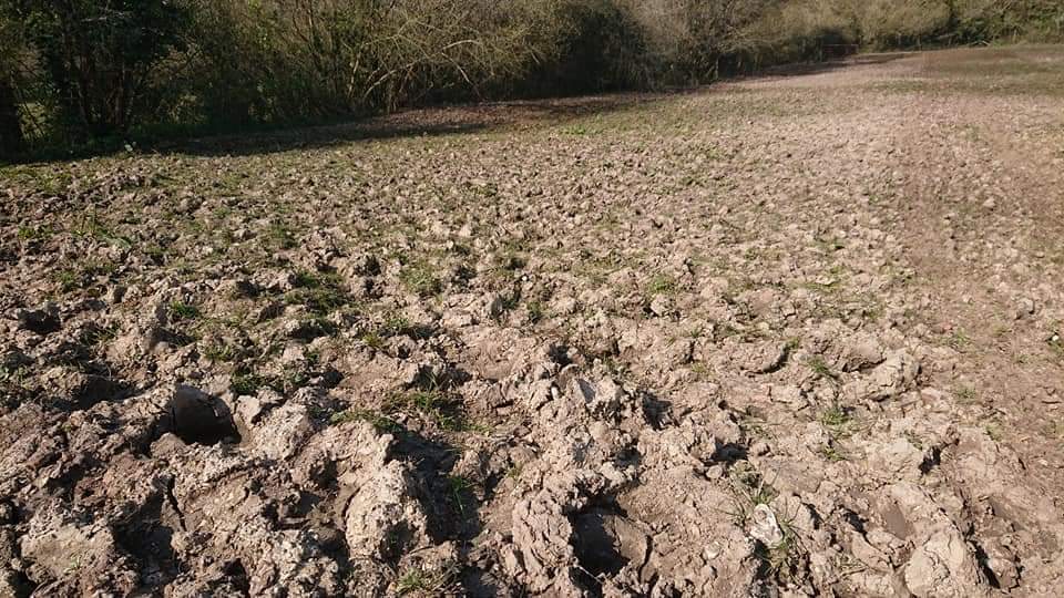 Rough cultivated field soil ready for grass seed