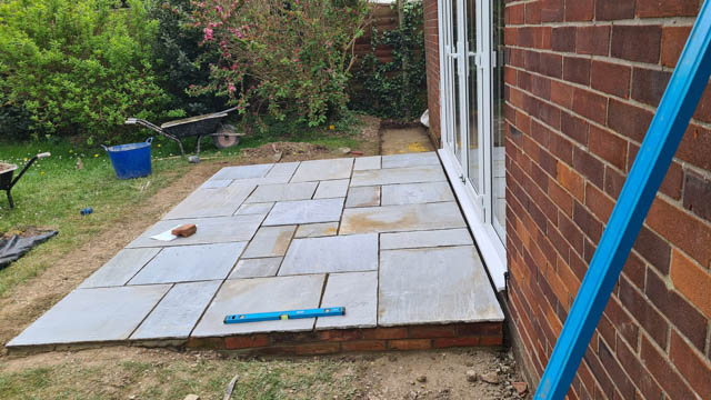 Newly laid stone patio as part of a garden landscaping project